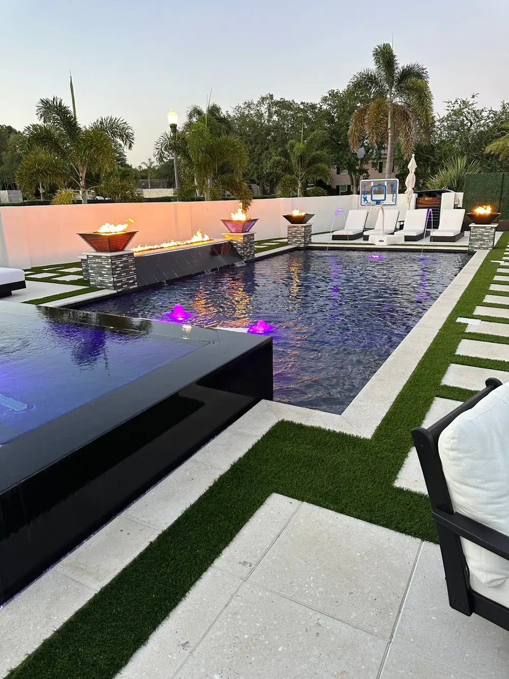 Modern rectangular pool at dusk — Culbreath Project custom pool project by Wahoo Pools in Tampa, FL
