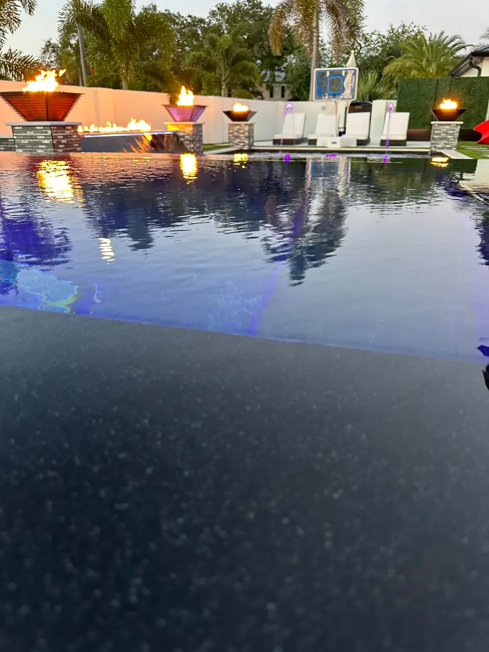 Evening lighting on modern pool — Culbreath Project custom pool project by Wahoo Pools in Tampa, FL