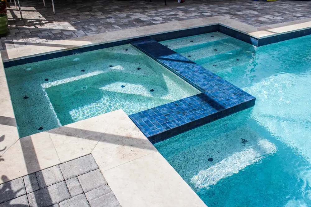 Stacked-stone accent wall — Lakeside Serenity custom pool project by Wahoo Pools in Tampa Bay lakefront