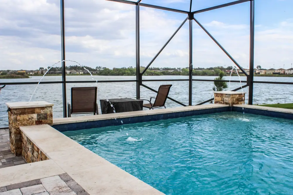 Lakefront pool with deck jets — Lakeside Serenity custom pool project by Wahoo Pools in Tampa Bay lakefront