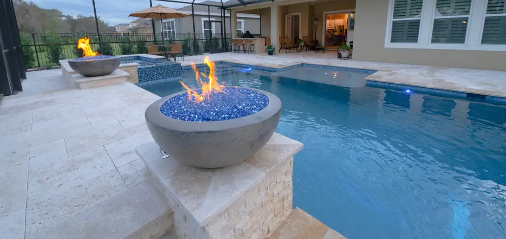 Screen-enclosed pool by the tree line — Lithia Forest custom pool project by Wahoo Pools in Lithia, FL