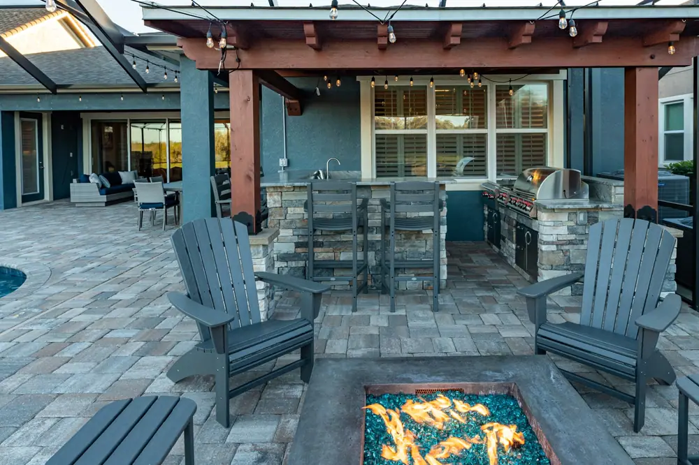 Outdoor kitchen and pergola — Backyard Oasis custom pool project by Wahoo Pools in Tampa Bay, FL