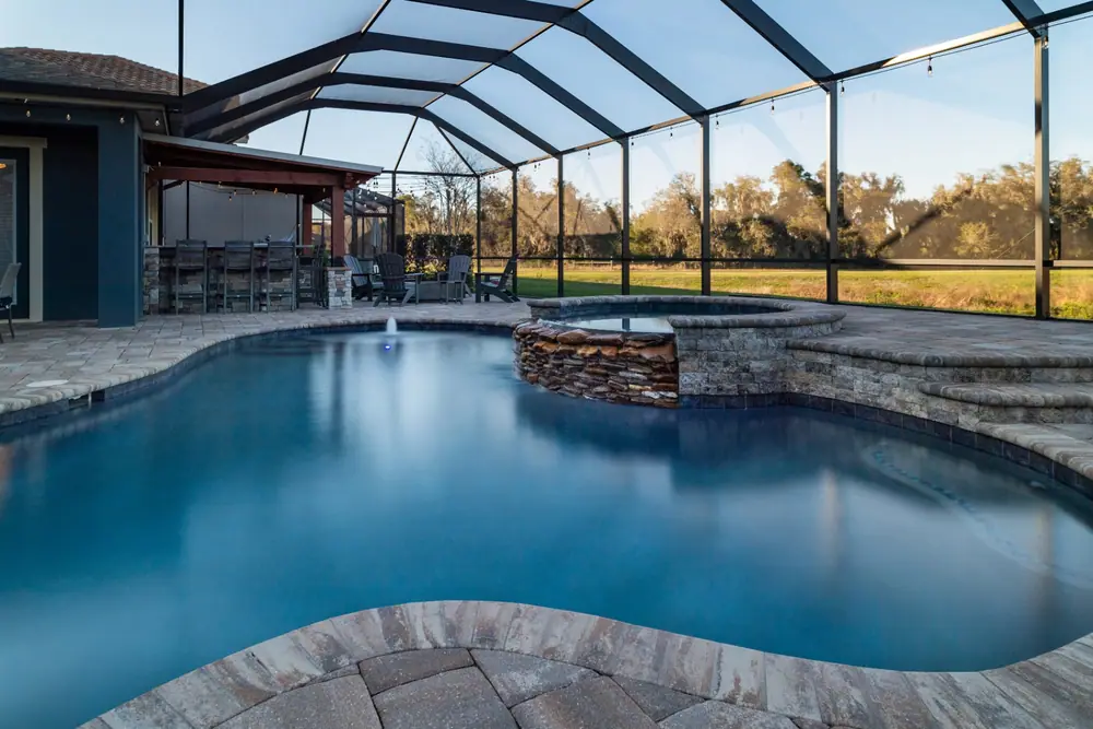 Stacked-stone spa spillway — Backyard Oasis custom pool project by Wahoo Pools in Tampa Bay, FL