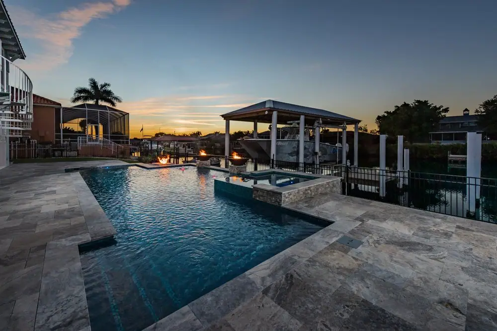 Raised spa with fire bowls — Reel Blessed Waterfront custom pool project by Wahoo Pools in Apollo Beach, FL