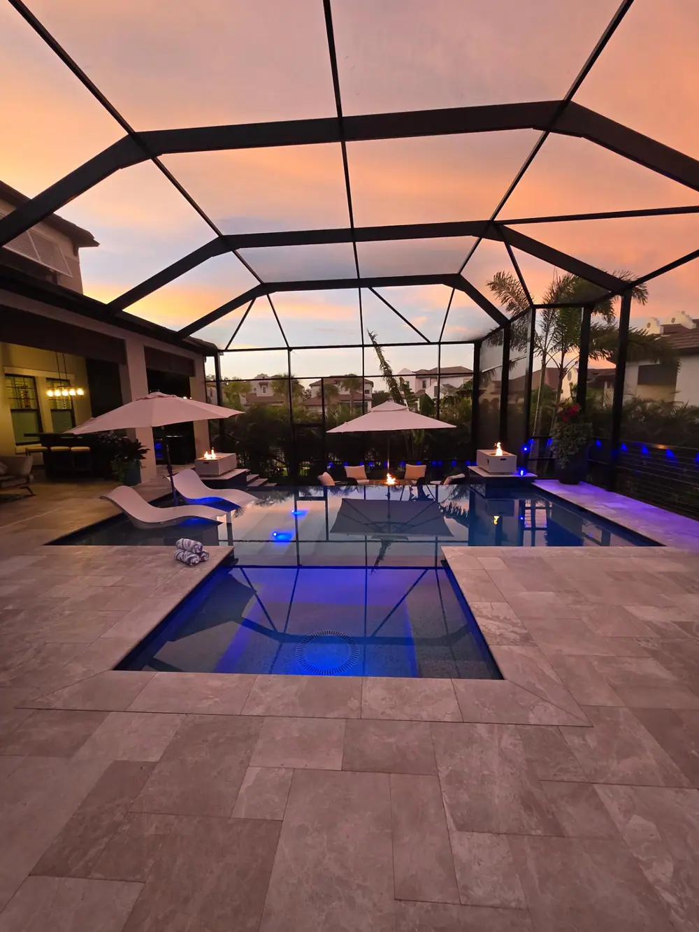 Sunset Lanai Retreat — flush spa and LED-lit pool under a pink Florida sky — Wahoo Pools project in Tampa, FL