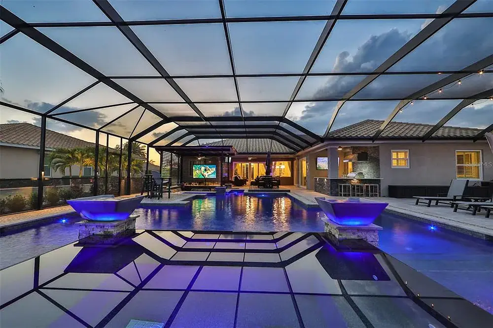 Timeless Project — classic Tampa pool with travertine deck at dusk — Wahoo Pools project in Tampa, FL