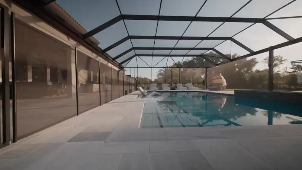 Twilight Lanai Estate — screen-enclosed pool with sun shelf and loungers in daylight — Wahoo Pools project in Tampa, FL