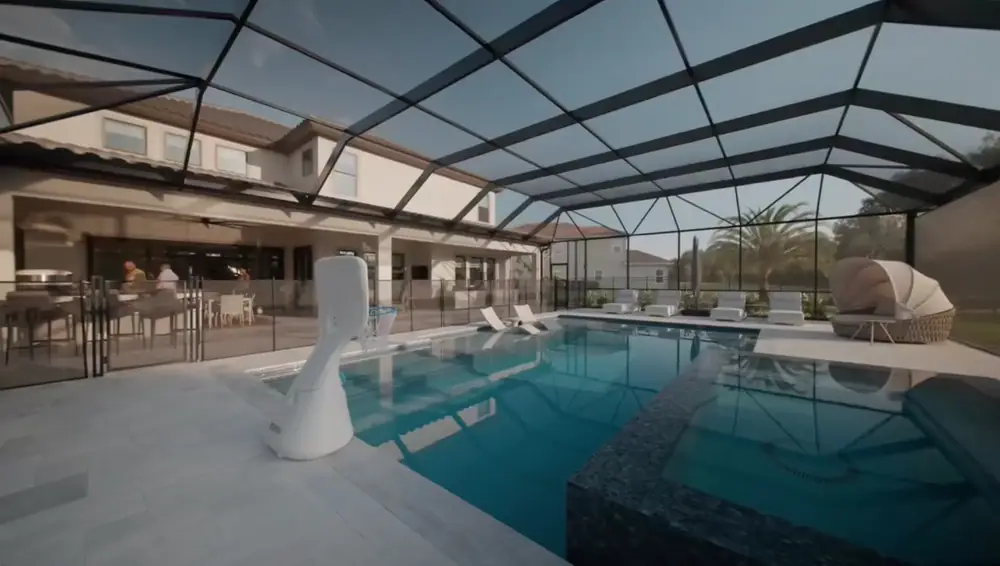 Twilight Lanai Estate — wide view of the screened pool, raised spa, and covered lanai — Wahoo Pools project in Tampa, FL