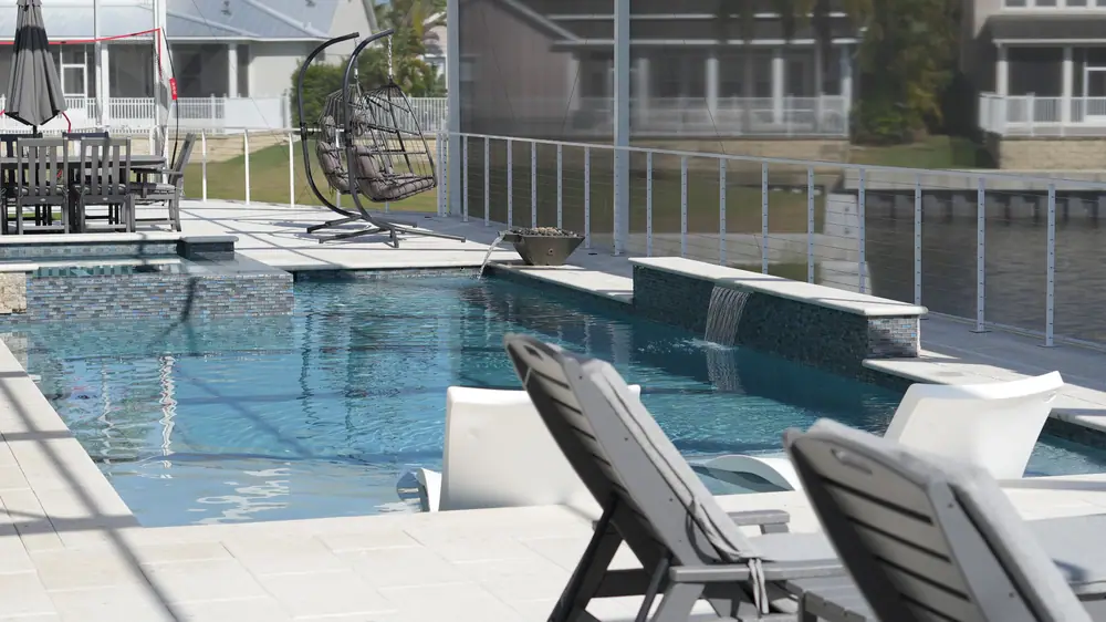Vera Canal Retreat — canal-front geometric pool with glass tile — Wahoo Pools project in Apollo Beach, FL