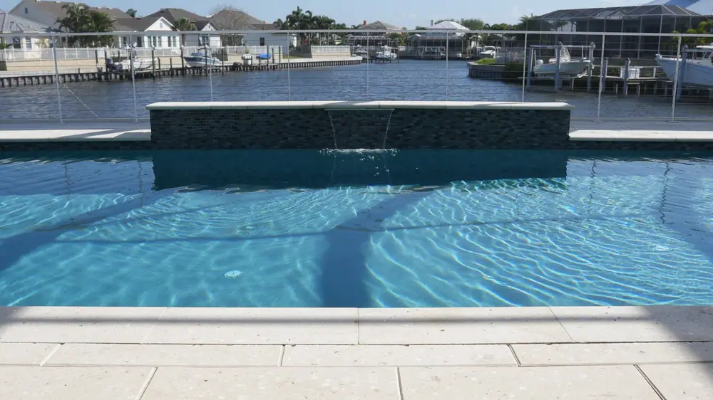Iridescent glass tile spa — Vera Canal Retreat custom pool project by Wahoo Pools in Apollo Beach, FL